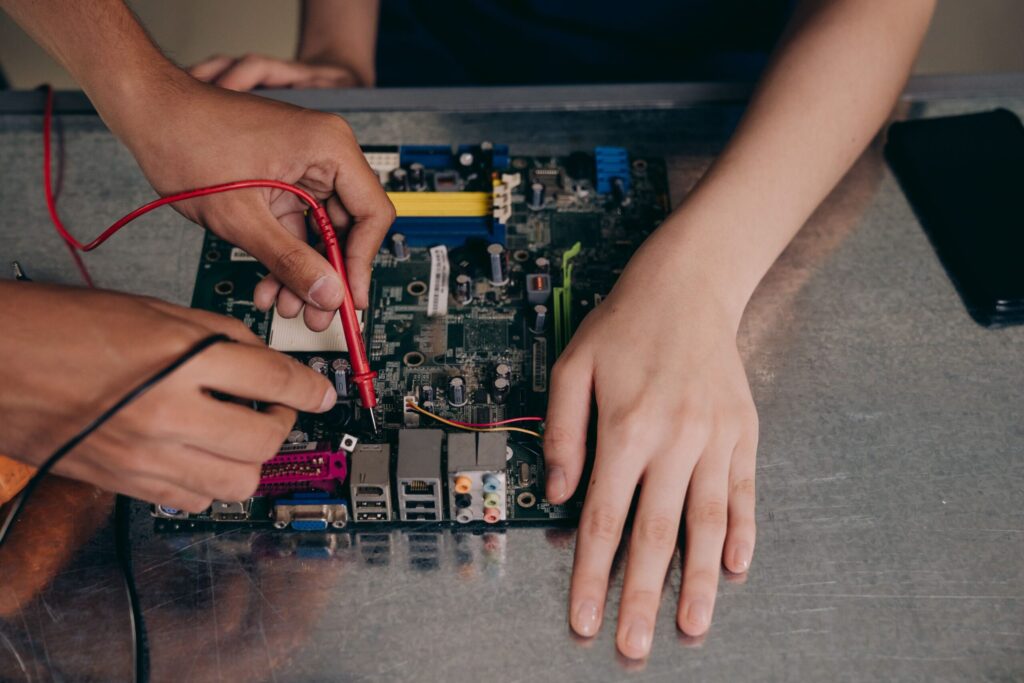 Technician repairing computer components under a seller or manufacturer warranty claim.
